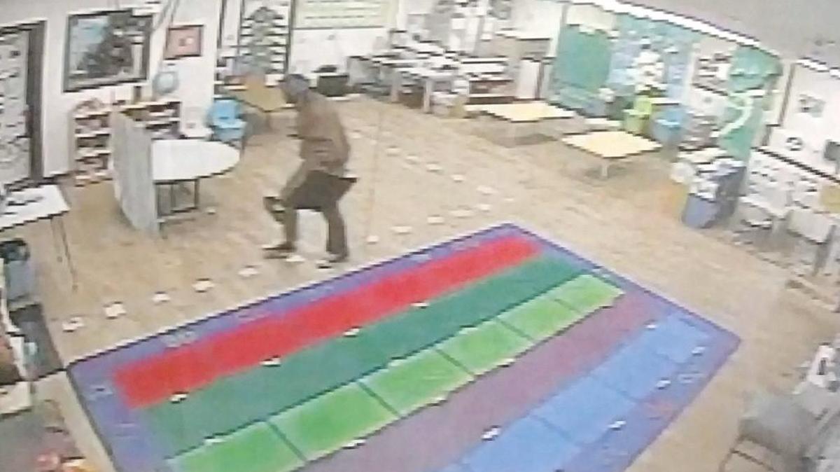 A photo from security video shows a man carrying a computer monitor across the room at Stone Soup Fresno during a Jan. 9 burglary.