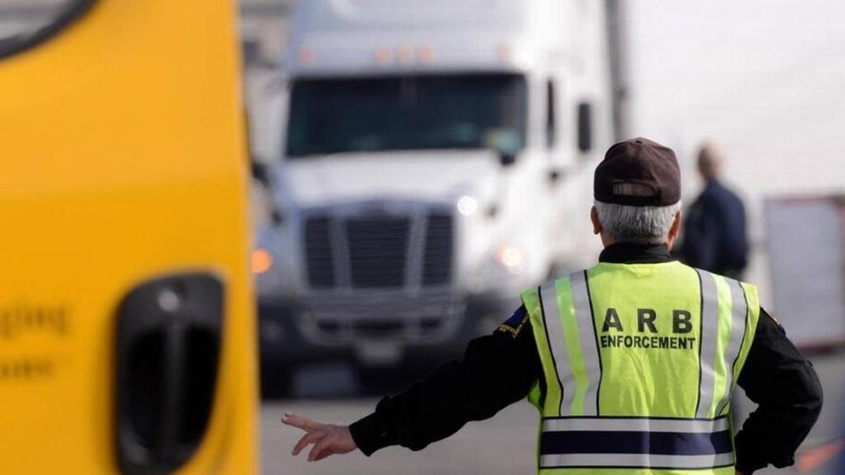 In this file photo, a California Air Resources Board field supervisor directs a truck during inspections on North Avenue, just off Highway 99, to check for compliance with state air pollution laws.