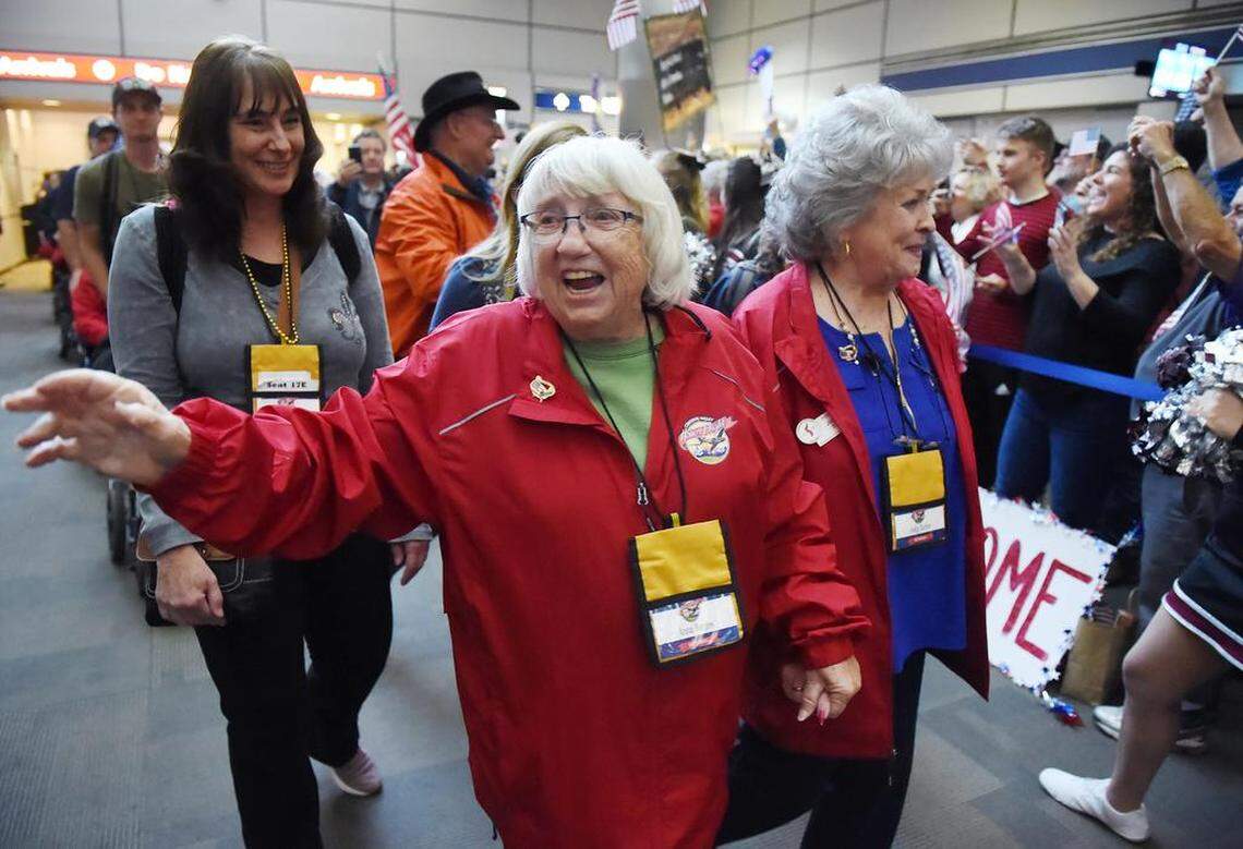 Air Force veteran Anna Borges, left, and Navy veteran Judy Tarter, right, lead the group of 70 veterans of the 18th Central Valley Honor Flight as they return to Fresno Yosemite International Airport Thursday, April 11, 2019 in Fresno. Anna met her husband Doug Borges who also flew on the Honor Flight. Doug served in WWII, Korea, and Vietnam in the Merchant Marine, Army Air Corp and Air Force.