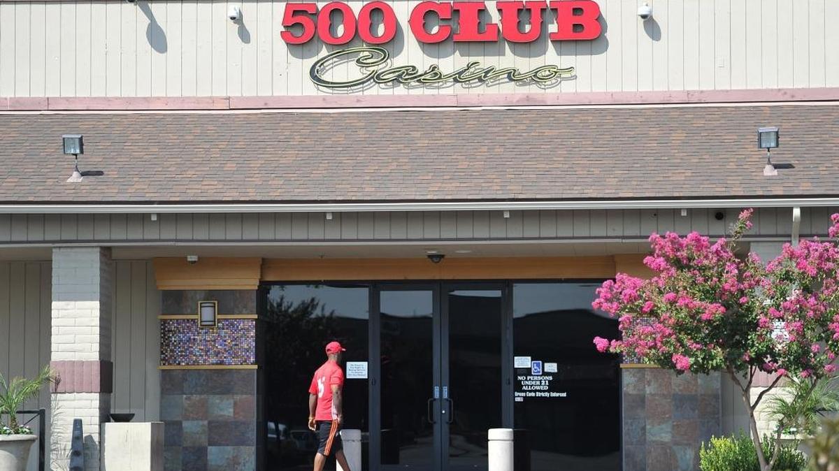 A patron enters the 500 Club at Shaw and Willow avenues in August after the card room reopened.