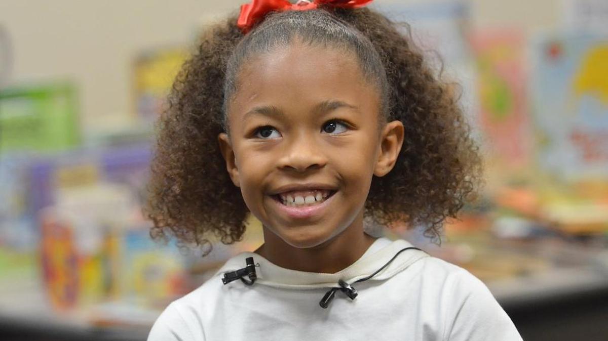 Fresno schoolgirl Danay Ferguson, 9, beams during a news conference in October 2015 to announce her partnership with the Fresno Police Department to donate 1,200 books for patrol officers to give to children in the city.