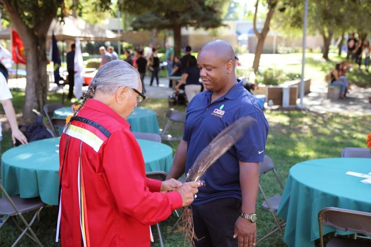 Eddie “Tupishna” Sartuche administers a Native American blessing a multicultural fair at College of the Sequoias in Visalia.