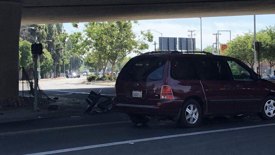 A van sits on Ventura Avenue after it was hit by a pole and a crumpled bicycle sits next to the van after an accident in downtown Fresno on Saturday morning, May 19, 2018.