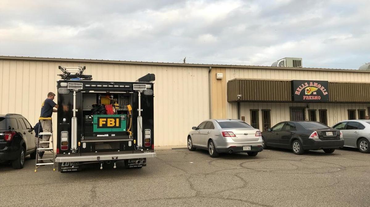 FBI agent outside the Fresno chapter office for the Hells Angels motorcycle club on Monday. A federal indictment charges the leader of the Fresno chapter with conspiracy to commit murder.