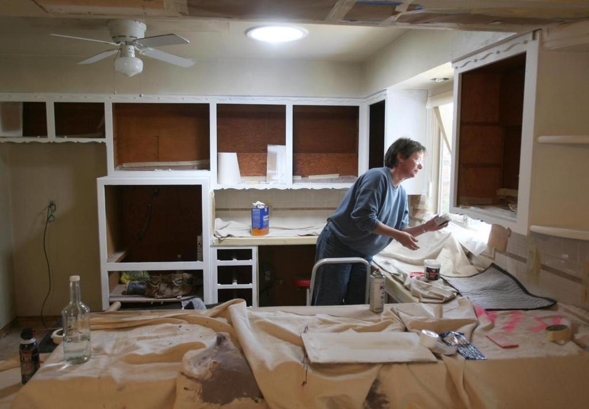 A contractor repaints the kitchen of a home near Fresno State in this Bee file photo. Repainting and other renovations are often part of the process for investors who buy older or financially distressed homes in hopes of “flipping” them for a fast profit.