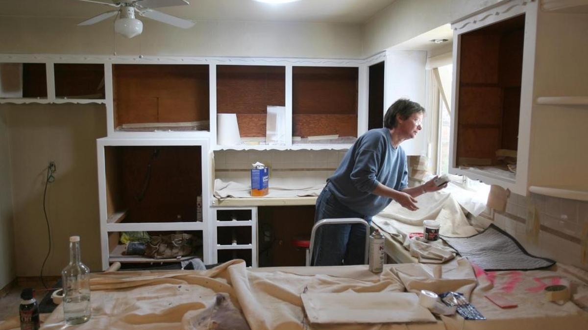A contractor repaints the kitchen of a home near Fresno State in this Bee file photo. Repainting and other renovations are often part of the process for investors who buy older or financially distressed homes in hopes of “flipping” them for a fast profit.