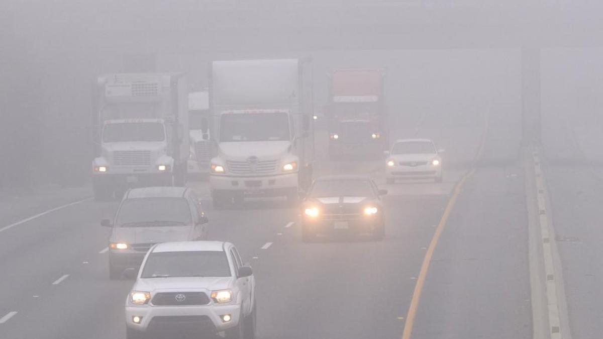 In a 2015 file photo, traffic moves along northbound Highway 99 in the dense fog.