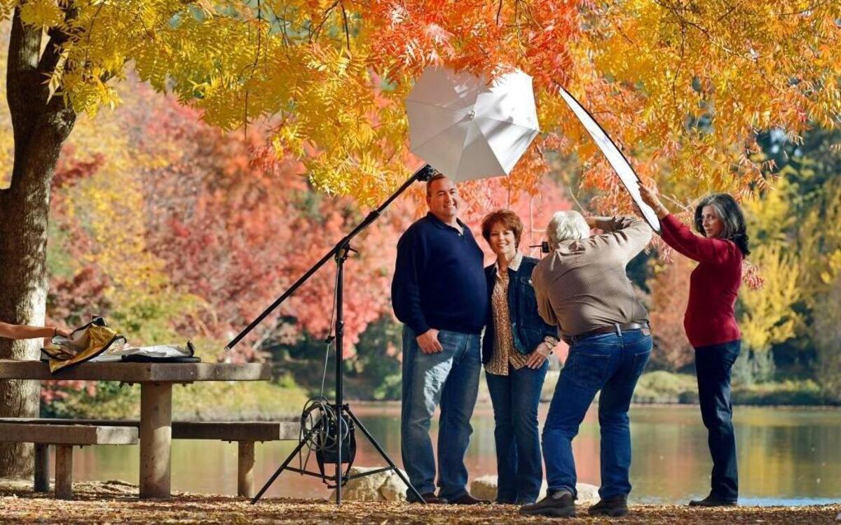 Photographer Rick Dodd, with help from his wife Sherri, right, photographs John and Tammy Maddox of Burrel against brilliant fall color backdrop at Woodward Park on a warm, clear day last November. Woodward Park would receive treated water for landscape irrigation under a plan supported by the City Council.