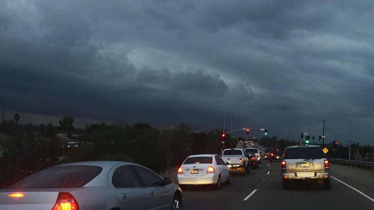 Ominous clouds cover the sky as traffic backs up on Highway 41 during the evening commute Monday.