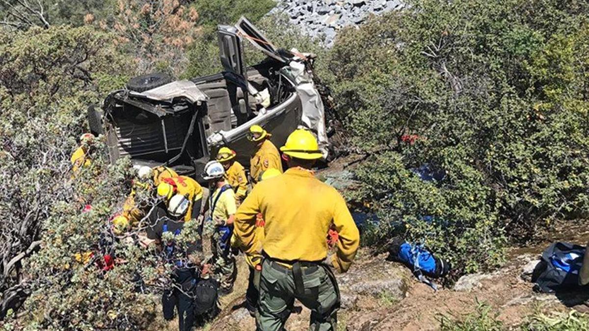 Rescuers Tuesday, May 2, 2017 at the scene of a crash down an embankment from Highway 168 on the four-lane section below Shaver Lake. Two people died and one survived.