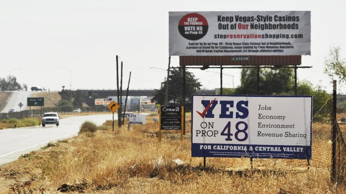 Proposition 48 campaign signs for, bottom, and against, top, seen just west of Highway 99 and north of Avenue 17 where the North Fork Rancheria of Mono Indians hope to begin construction of a casino.