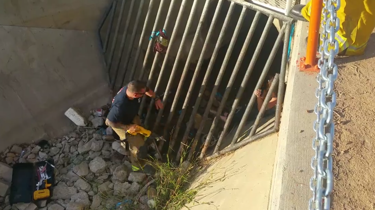 
Firefighter Nick Esqueda with Cal Fire frees a Madera woman who became trapped in a drainage canal. 
