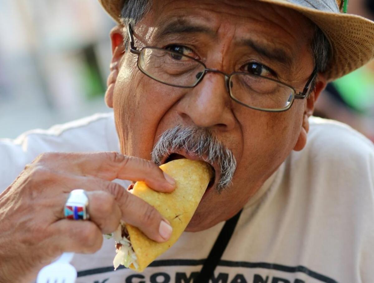 A season-high crowd of 14,651 showed up for the 2016 Taco Truck Throwdown at Chukchansi Park. Fresno’s Héctor Cortez bites into a carne asada taco from La Jacko Mobile.