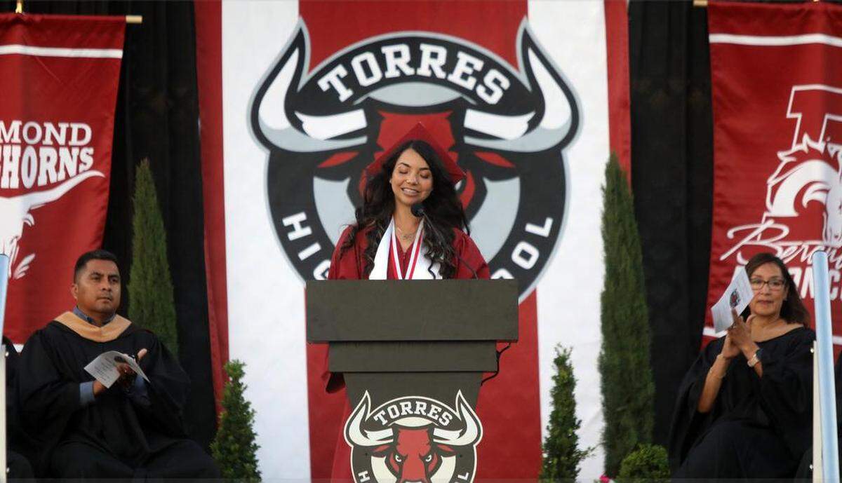 Senior class president Ashley Rico Díaz announces a gift of a topiary during the first graduation ceremony for Matilda Torres High School at Madera Memorial Stadium on June 10, 2023.