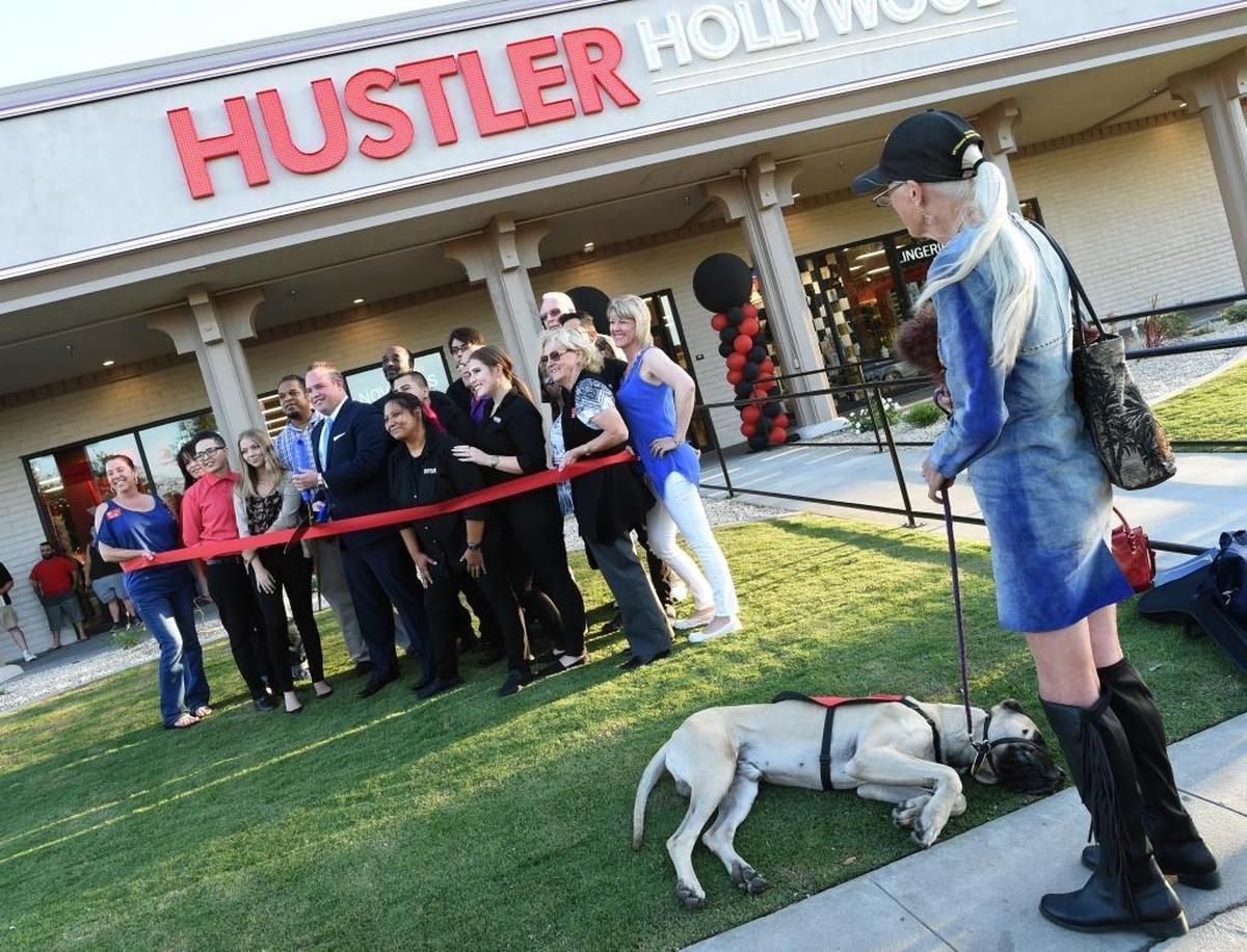Old English mastiff Sir Winston Churchill III snoozes as owner Carolyn Allison takes in the ribbon-cutting during the grand opening of Hustler Hollywood in Fresno, Saturday evening, Sept. 30, 2017.