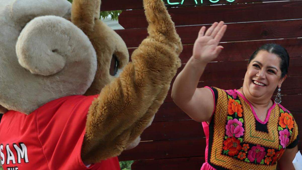 Consul General Adriana González Carrillo gives a high five to the Fresno City College Ram mascot at the Mexican Independence Day celebration at Fresno City College on Sept. 15, 2023.