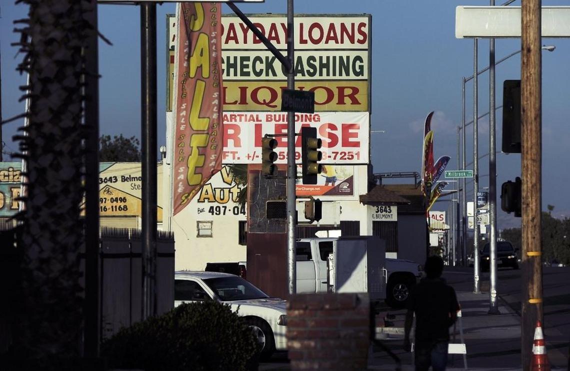 A liquor store competes with other businesses including a check cashing company along Belmont Avenue in southeast Fresno.