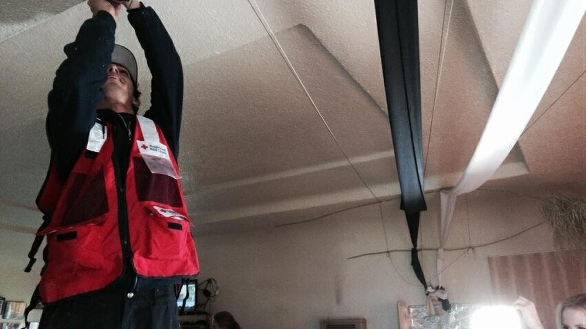Volunteer Derek Podergois installs a smoke alarm Saturday morning in a Fresno home.