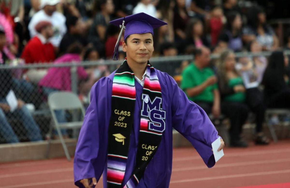 A Madera South High graduate walks to his seat during the graduation ceremony at Madera Memorial Stadium on June 7, 2023.