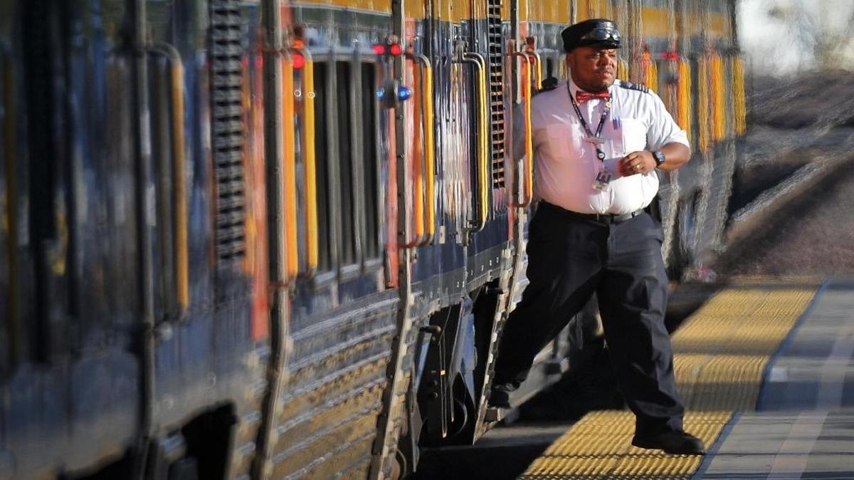 An Amtrak conductor makes a last check for travelers departing on a southbound train at the Fresno station, Nov. 21, 2016.