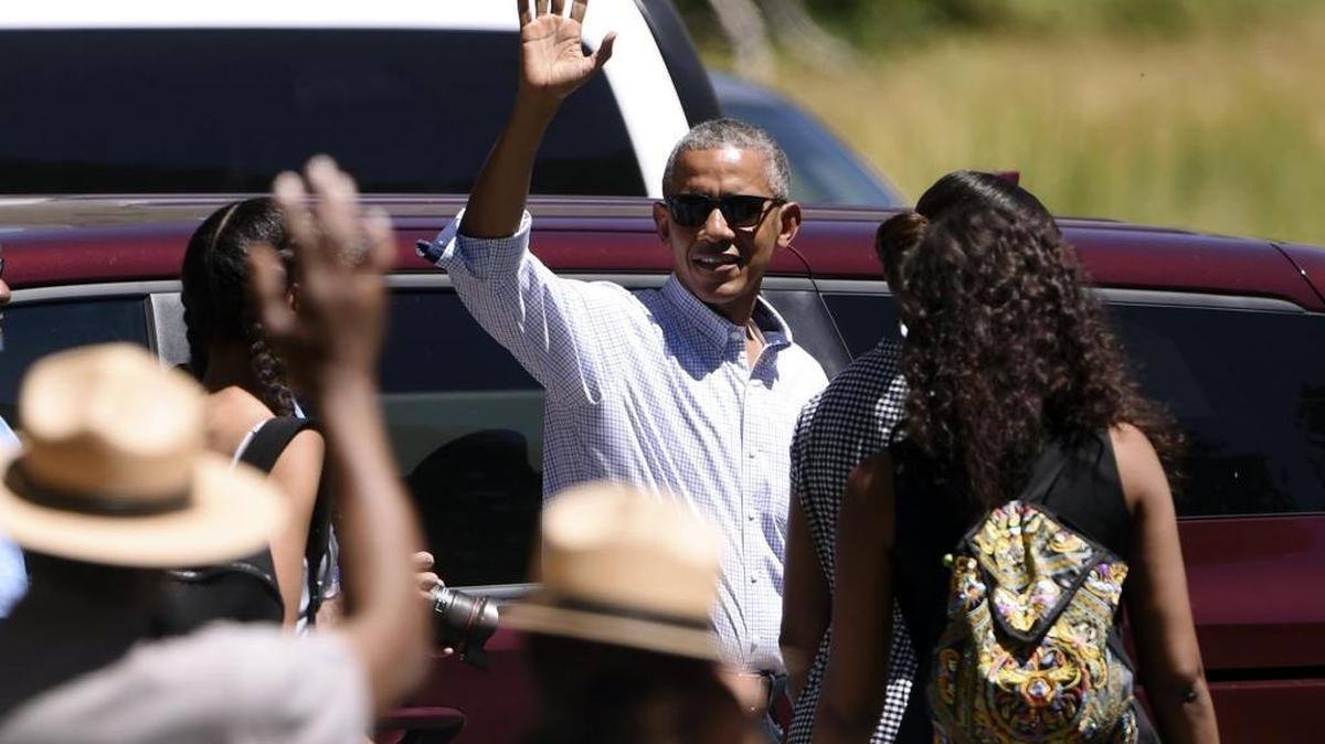 President Barack Obama waves as he and the first family leave Yosemite Valley on Marine One from Ahwahnee Meadow, where a public viewing area was sectioned off across the road Sunday.