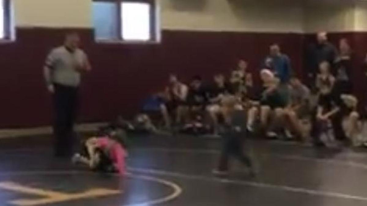 During a youth wrestling match in Columbia City, Ind., 2-year-old Jash Lewis, unaware it’s not a fight, runs out on the mat to help 4-year-old sister Ruby.
