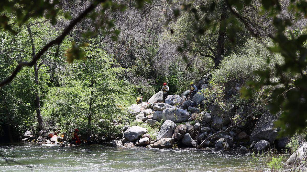 Search teams scoured a California national park river for a 26-year-old woman who was swept away during Memorial Day weekend, rangers said.