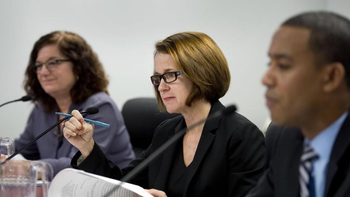 Jodi Remke, center, flanked by commissioners Patricia Wynne, left, and Eric Casher conduct business on Thursday, Nov. 20, 2014 in Sacramento, Calif.