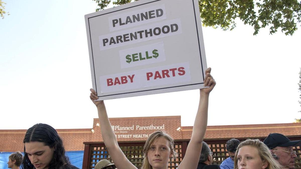 
Hanna Keller, 19, center, and her sister Janae Keller, 13, both of Rocklin, Calif. joined anti abortion-rights protesters at Planned Parenthood in Sacramento to protest recent videos showing the non-profit negotiating to sell fetal tissue during a rally on Tues., July 28, 2015 in Sacramento, Calif. 
