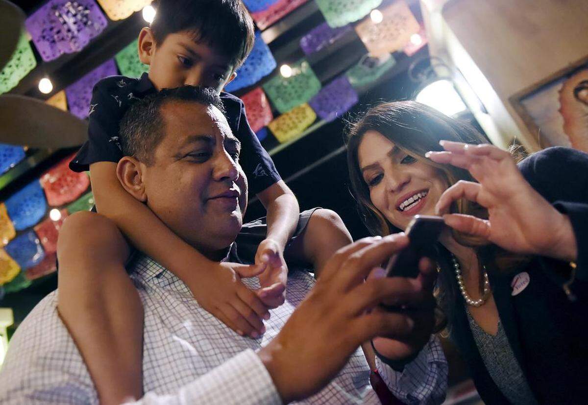 On Election Night 2018 newly elected Fresno City Councilmember Miguel Arias, with son Diego Arias perched on his shoulders, looks over polling results with Councilmember Esmeralda Soria.