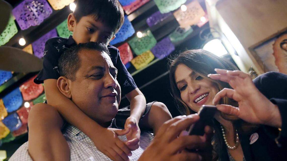 On Election Night 2018 newly elected Fresno City Councilmember Miguel Arias, with son Diego Arias perched on his shoulders, looks over polling results with Councilmember Esmeralda Soria.