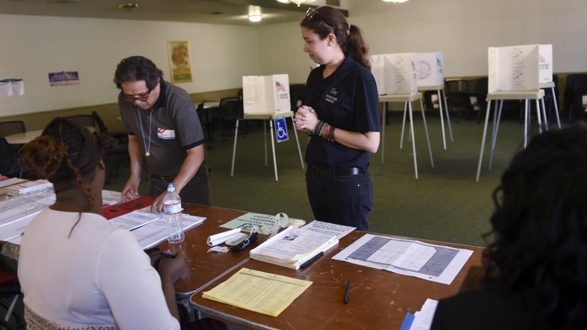Candle Cee, right, arrives to vote at a polling place on the Fresno City College campus in the June 2016 primary election.