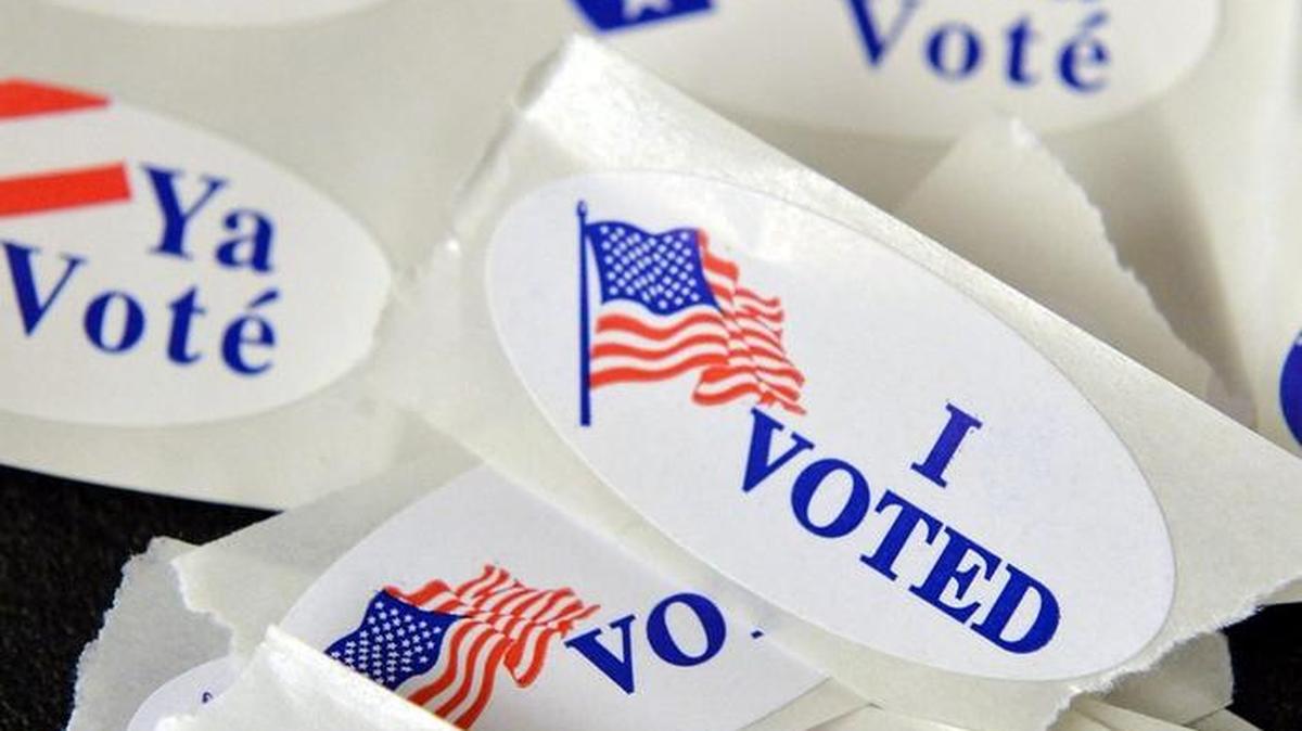 “I voted” stickers in English and Spanish are handed out Tuesday, Nov. 8, 2016, at the Boy Scouts of America polling place in northwest Fresno.