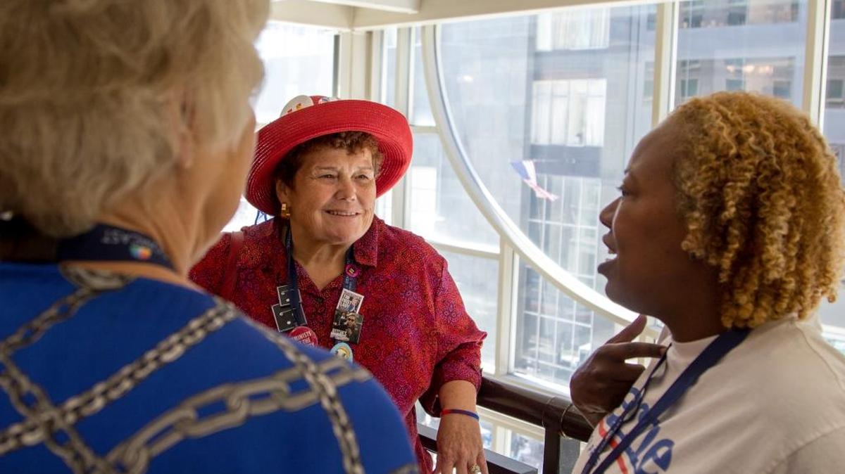 Clinton delegates Marsha Conant and Judy Lund-Bell socialize with Sanders delegate Yamina Roland. They aren’t talking about politics – they’re talking about their daughters.