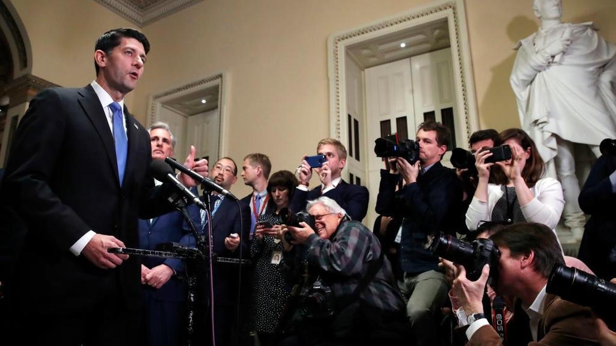 House Speaker Paul Ryan, left, speaks at a news conference after the House voted to approve the Republican tax bill Tuesday, Dec. 19, 2017, on Capitol Hill in Washington.