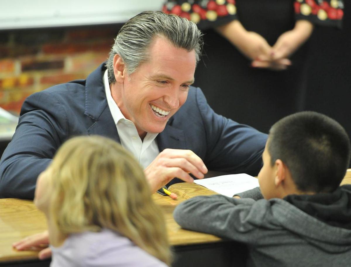 California Gov. Gavin Newsom chats with Riverview Elementary first-grader Juan Salcedo as to whether Newsom should sign AB 72, an early action budget bill that provides urgent assistance for communities that have contaminated and unsafe water. Newsom visited the school east of Parlier for his first bill signing on Wednesday, Feb. 13, 2019.