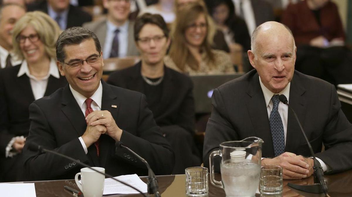 Xavier Becerra, left, laughs at a comment by Gov. Jerry Brown during his Assembly confirmation hearing for attorney general this month. Becerra was confirmed on Monday and Brown on Tuesday swore him into the office before delivering his State of the State address.