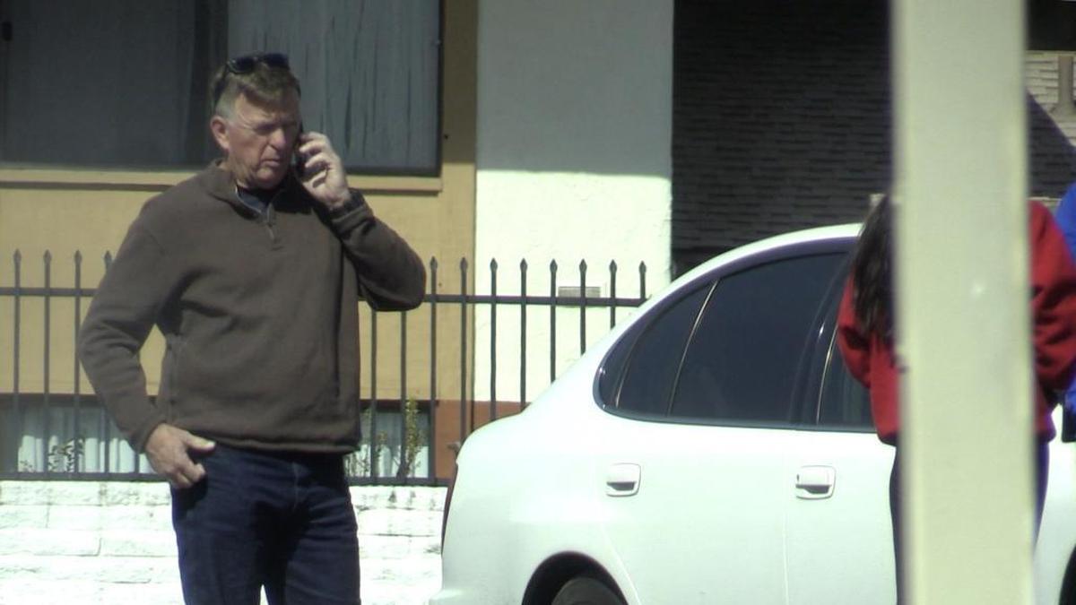 Fresno police Sgt. Curt Chastain, left, speaks with a 15-year-old human trafficking victim (at right, partially hidden by post) found during an undercover operation.