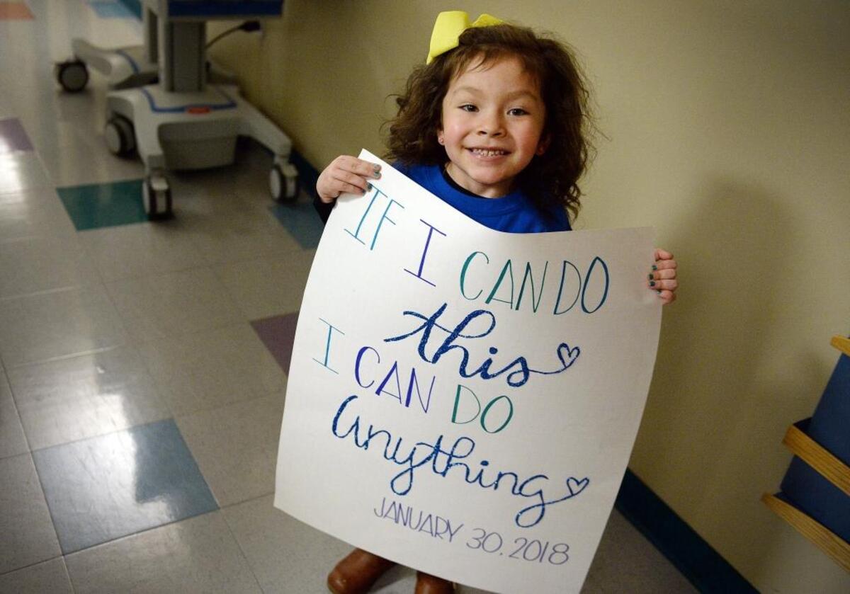 Samantha “Sammy” Leal, 4 holds up a sign celebrating the last day of her chemotherapy treatments for a tumor at Valley Children’s Hospital on Monday, Jan. 30, 2018.