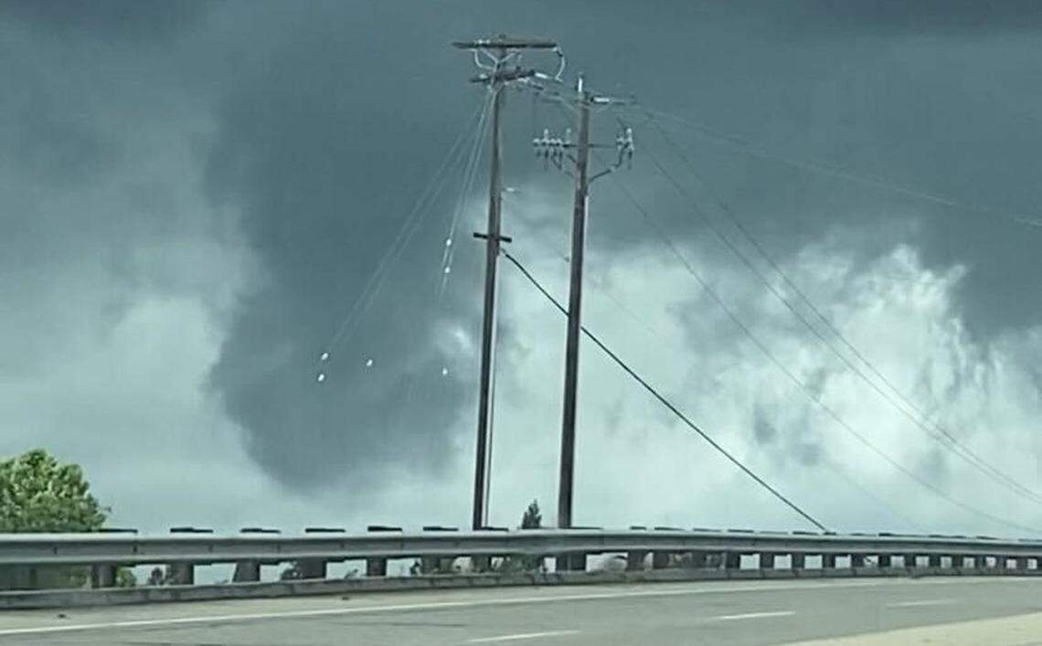 A small tornado funnel, confirmed by the National Weather Service, forms near Highway 99 and Herndon Avenue on Tuesday afternoon, though it didn’t touch down.