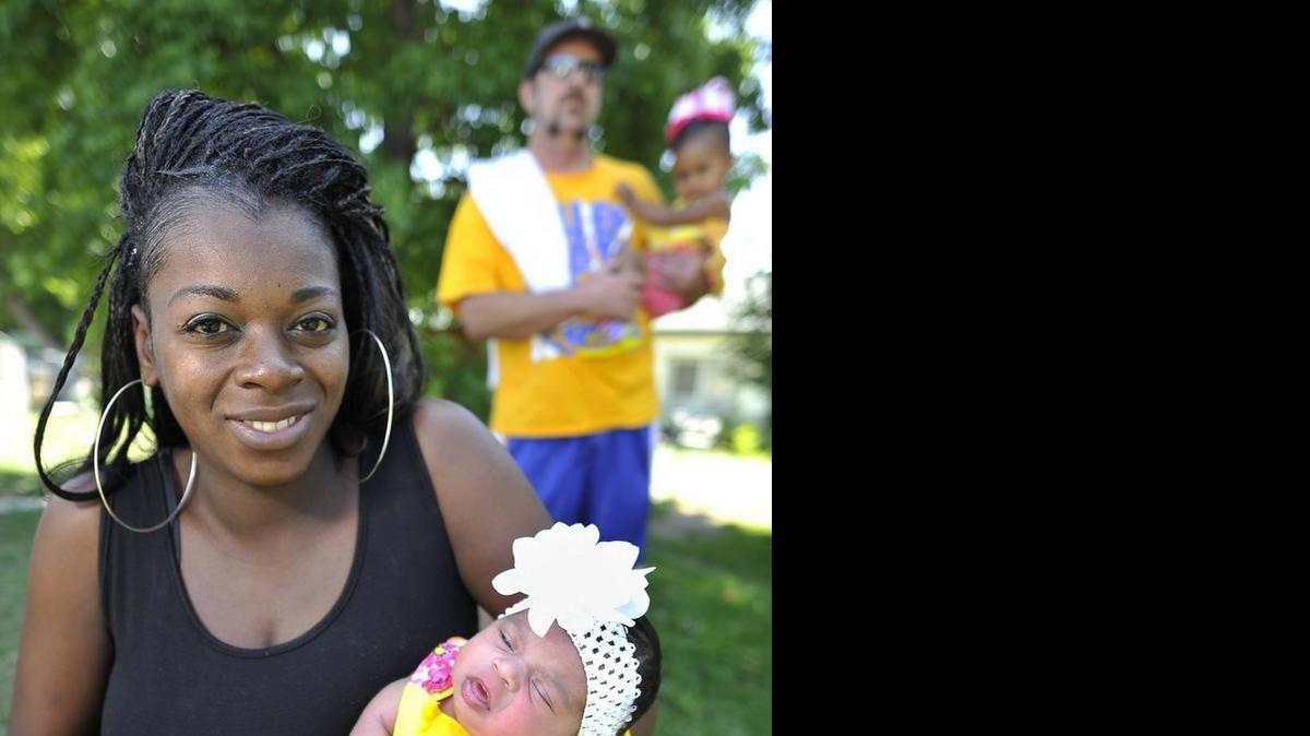 
Maktius Hayes holds then two-week-old Serenity Secoy in May, as husband Steve Secoy holds their 18-month-daughter, Autumn Secoy. Her first-born daughter, now five, was born at 29 weeks. Hayes credits a Black Infant Health program at the Fresno County Department of Public Health for helping her have a healthy 7-pound, 15-ounce baby this time.
