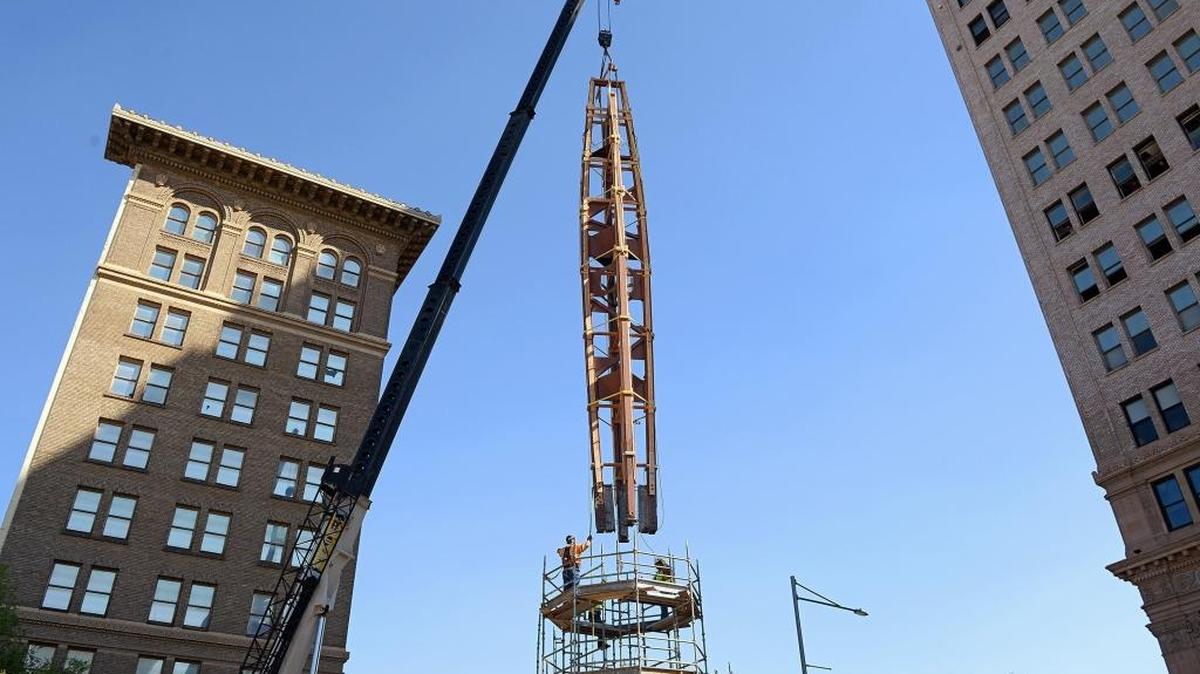 Workers lower the Fulton Mall clock tower into its new location about 30 feet to the southwest from its old spot in the middle of Fulton and Mariposa streets on July 18. The clock tower, first put into place in the Fulton Mall in 1964, will be restored in its new spot which will allow traffic to pass when the Fulton Street restoration project is completed.