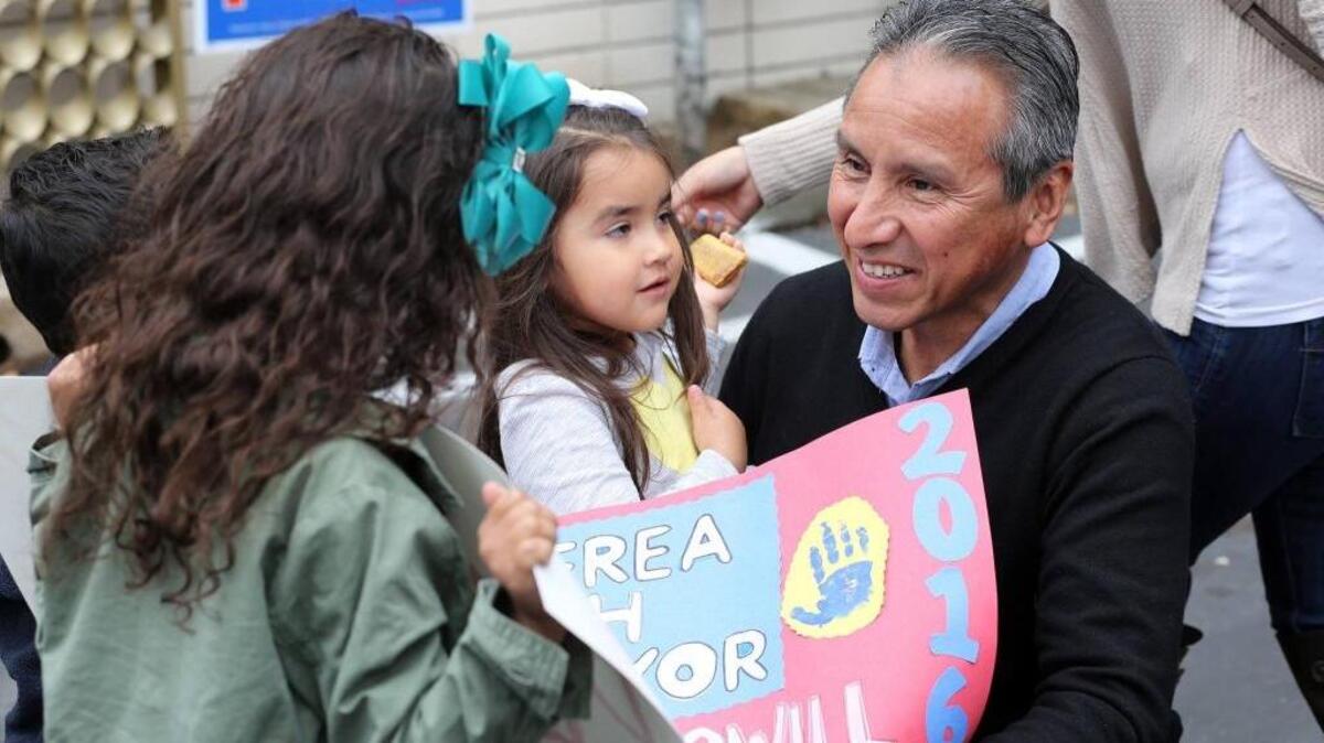 In this March 5, 2016, photo, Fresno County Supervisor Henry R. Perea launches his campaign for Fresno mayor with a brief rally at his Tower District campaign office before sending out volunteers to go knocking on doors. Here, he meets granddaughter Sophia Perea, who made him a campaign sign.