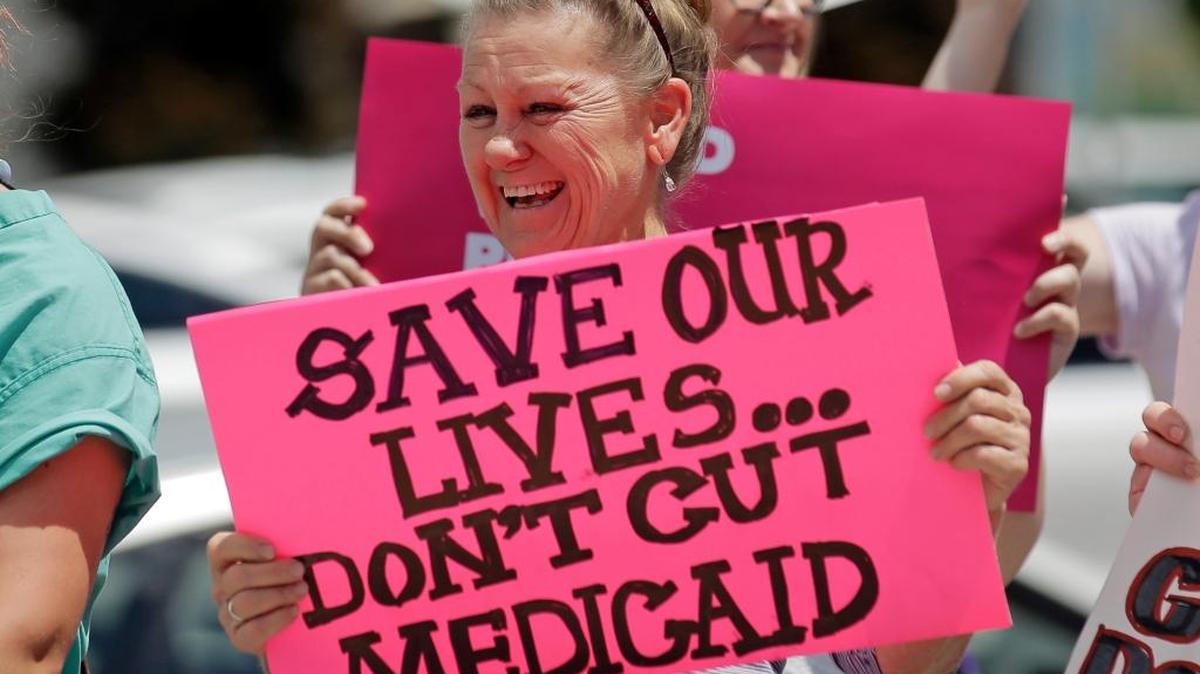 Protesters block a street during a protest against the Republican bill in the U.S. Senate to replace President Barack Obama’s health care law Tuesday, June 27, 2017, in Salt Lake City. The protesters criticized Utah Republican Sen. Orrin Hatch for supporting the bill and say it will cut life-saving Medicaid services.