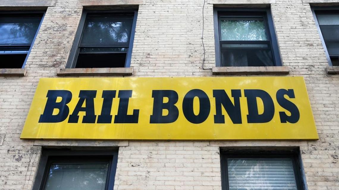 A bail bonds sign hangs on the side of a building in New York.