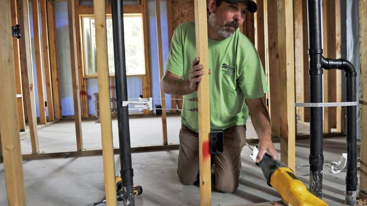 Site supervisor Greg Rounsiviol retrieves a reciprocating saw as contractors continue construction at a Habitat for Humanity home that was under construction in Hope Village near Church and Laval Avenues in Fresno.