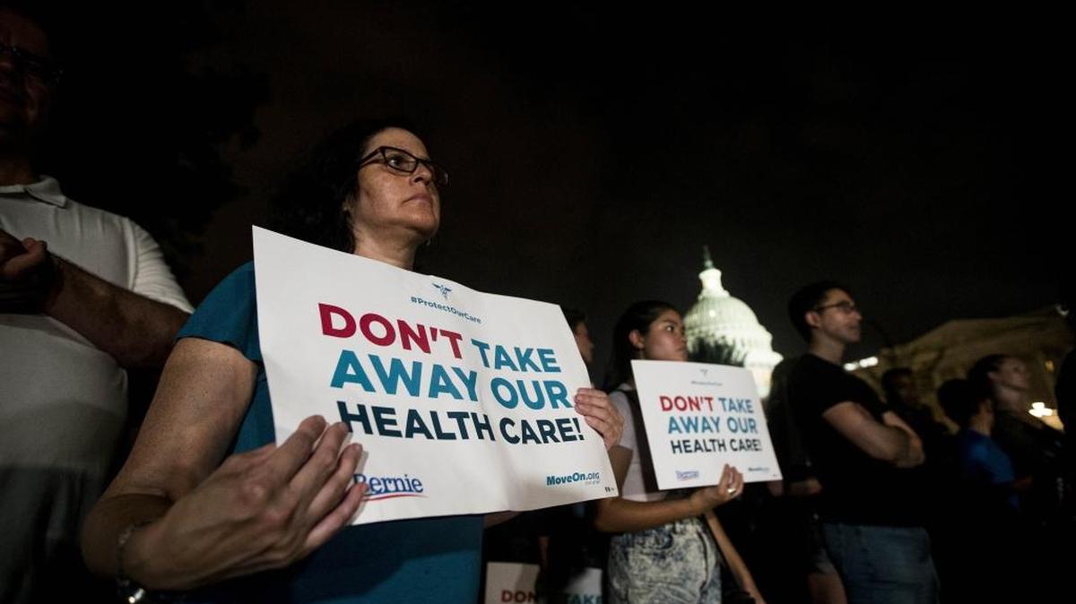 Protestors rally outside the U.S. Capitol on Thursday night before the Senate rejected a bill to repeal the Affordable Care Act.