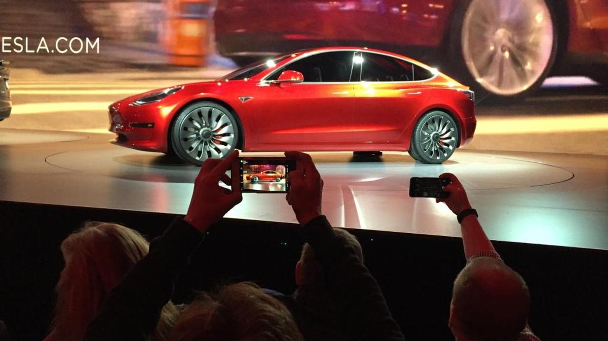 Tesla Motors unveils the new lower-priced Model 3 sedan at the Tesla Motors design studio in Hawthorne last March. Production of the car will begin later this year.