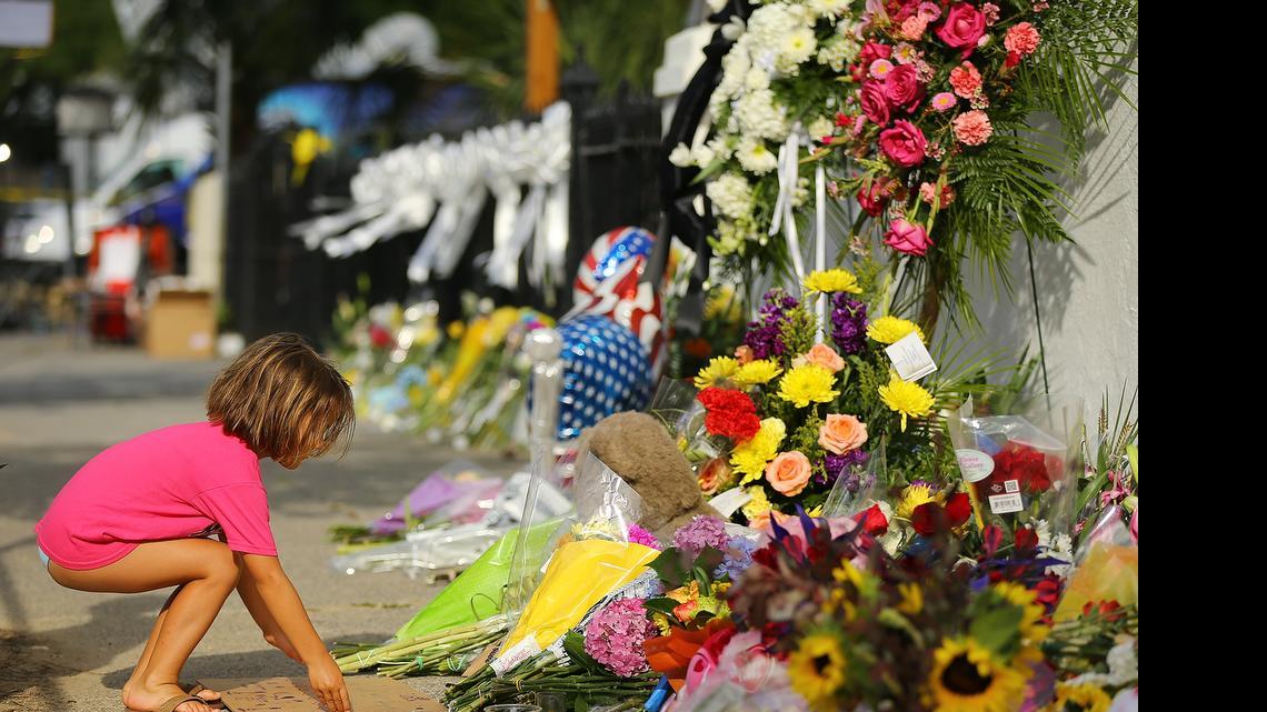 
Lydia Blessing, 4, places a handwritten note at a memorial in front of the Emanuel AME Church on Friday
