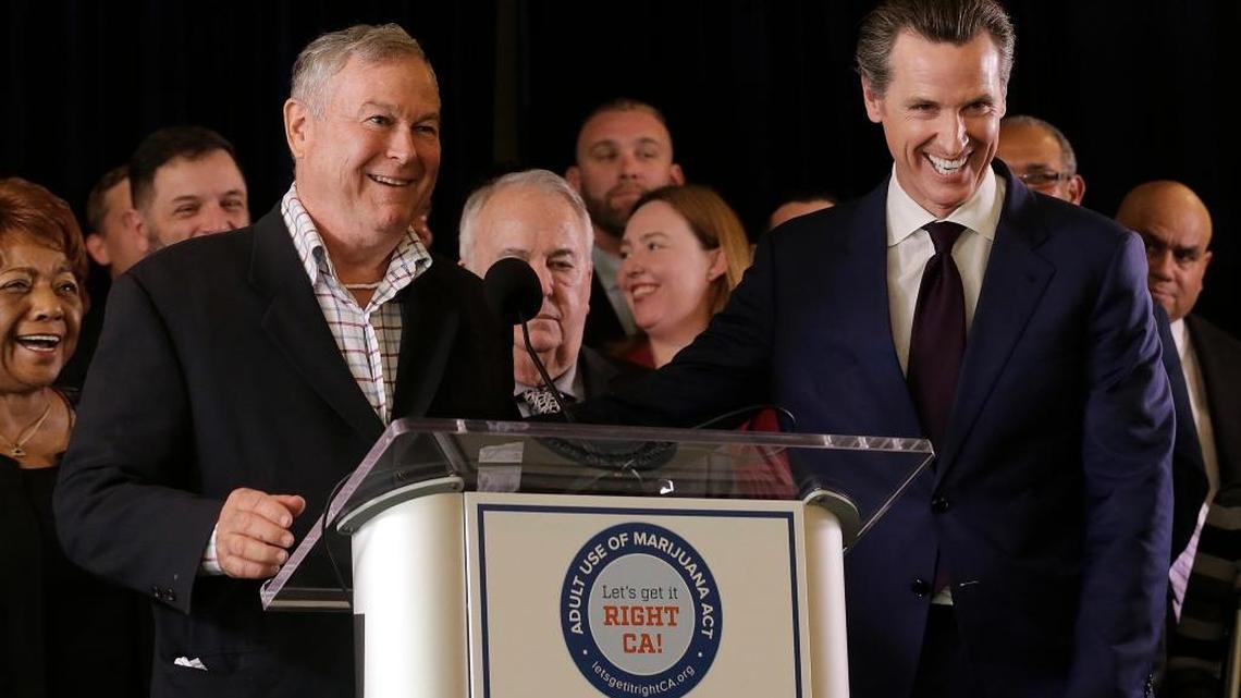 Rep. Dana Rohrabacher, R-Calif., left, smiles next to Lt. Gov. Gavin Newsom at a news conference after speaking in support of the Adult Use of Marijuana Act ballot measure in San Francisco May 4.